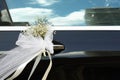 Wedding bouquet of fresh flowers on the doorknob of a wedding car Royalty Free Stock Photo