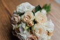Wedding bouquet of fresh flowers, a pair of gold rings close-up. Wedding details