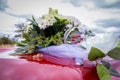 Wedding bouquet with golden rings on the hood of the car Royalty Free Stock Photo