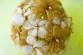 Wedding bouquet golden and white flowers from beads. On a yellow blurred background. Royalty Free Stock Photo