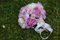 Wedding bouquet on green grass. Bride & flowers Royalty Free Stock Photo