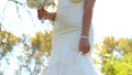 Wedding bouquet in hands of beautiful bride in white wedding dress