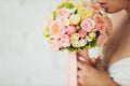 Wedding bouquet in hands of the bride. Royalty Free Stock Photo