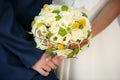 Wedding bouquet in hands of the bride and groom Royalty Free Stock Photo