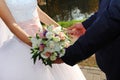 Wedding bouquet in the hands of the bride and groom Royalty Free Stock Photo