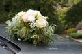 Wedding bouquet on the hood of the car Royalty Free Stock Photo