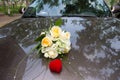 Wedding bouquet on the hood of the car and a red box with rings Royalty Free Stock Photo