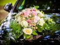 Wedding bouquet on the hood of a black retro car Royalty Free Stock Photo