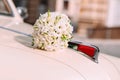 wedding bouquet hood white retro car outside Royalty Free Stock Photo