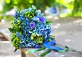 A wedding bouquet with hydrangea in blue and green colors