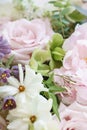 Wedding bouquet of jasmine, roses, peony and buttercup. Lots of greenery, modern asymmetrical disheveled bridal bunch