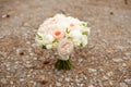 Wedding bouquet lying on grey carpet during preparation before celebration. Side view of decorative rose,peonies flowers and