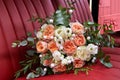 Wedding bouquet lying on a red leather car seat Royalty Free Stock Photo