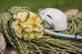 A wedding bouquet made of white roses on a rope with an ice ax Royalty Free Stock Photo