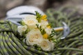 A wedding bouquet made of white roses on a rope with an ice ax Royalty Free Stock Photo