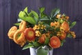 Wedding bouquet with orange Ranunculus and Ornithogalum Dubium on the wooden background