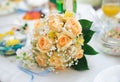 Wedding bouquet of orange roses lying on a table Royalty Free Stock Photo