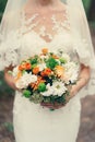 Wedding bouquet of orange roses, white and orange chrysanthemums. Royalty Free Stock Photo