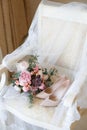 Wedding bouquet of peonies lying on the chair
