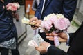 Wedding bouquet of peony at hands of groom with moneys. Redemption of bride on wedding