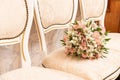 Wedding bouquet of pink daises and white roses on beach chair Royalty Free Stock Photo