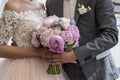 Wedding bouquet of pink and lilac peonies in bride`s and groom`s hands Royalty Free Stock Photo