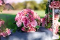 Wedding bouquet of pink, pastel roses outdoors on the swing decorated with fresh flowers. Spring flowers. Bridal. Wedding outdoor Royalty Free Stock Photo