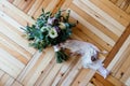 Wedding bouquet of purple and white flowers tied