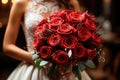 Wedding bouquet of red roses close-up in the hands of the bride