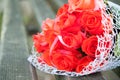 Wedding bouquet of red roses lies on the bench. Fragrant flowers, smell beautiful Royalty Free Stock Photo