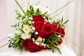 Wedding bouquet of red roses, white daisies and other flowers Royalty Free Stock Photo