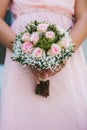Wedding bouquet of flowers in brides` hands