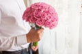 Wedding bouquet of roses in the hands of the groom