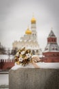 Wedding bouquet on the street on the background of the Orthodox Cathedral with Golden domes of the Moscow Kremlin