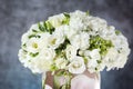 Wedding bouquet in a vase with white roses under the water drops on the mirror against grey and blue background. Royalty Free Stock Photo