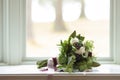 Wedding bouquet with vintage ribbon on a window sill with shallow depth of field Royalty Free Stock Photo