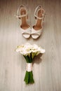 Wedding bouquet of white callas. Tender white flowers and white high heels female shoes, flat lay, close up Royalty Free Stock Photo