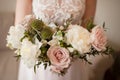 Wedding bouquet of white peony and coffee roses. Lots of greenery. Royalty Free Stock Photo