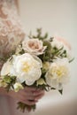 Wedding bouquet of white peony and coffee roses. Lots of greenery. Royalty Free Stock Photo