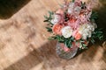 Wedding bouquet of white peony and pink roses wooden table. Lots of greenery, modern asymmetrical disheveled bridal