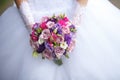 Wedding bouquet of white red and pink roses in bride hands Royalty Free Stock Photo