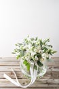 Wedding bouquet of white roses and buttercups on a wooden table. old rustic background Royalty Free Stock Photo