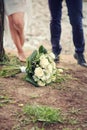 Wedding bouquet of white roses in the foreground.