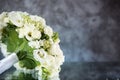 Wedding bouquet with white roses under the water drops on the mirror against grey and blue background. Royalty Free Stock Photo