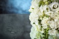 Wedding bouquet with white roses under the water drops on the mirror against grey and blue background. Royalty Free Stock Photo