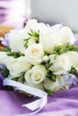 Wedding bouquet with white roses on violet background