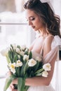 Wedding bouquet of white tulips in the hands of a beautiful bride. Selective Focus Royalty Free Stock Photo