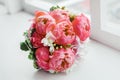 Wedding bouquet on window sill. Royalty Free Stock Photo