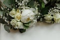 Wedding bouquets of white roses and greens for bridesmaids on a white table. brides morning. wedding accessories. selective focus Royalty Free Stock Photo