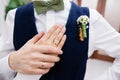 Wedding boutonniere and hands of bride and groom Royalty Free Stock Photo